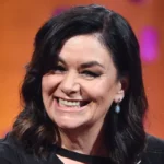Dawn French looks almost unrecognisable with dramatic updo and daring Vivienne Westwood bow dress